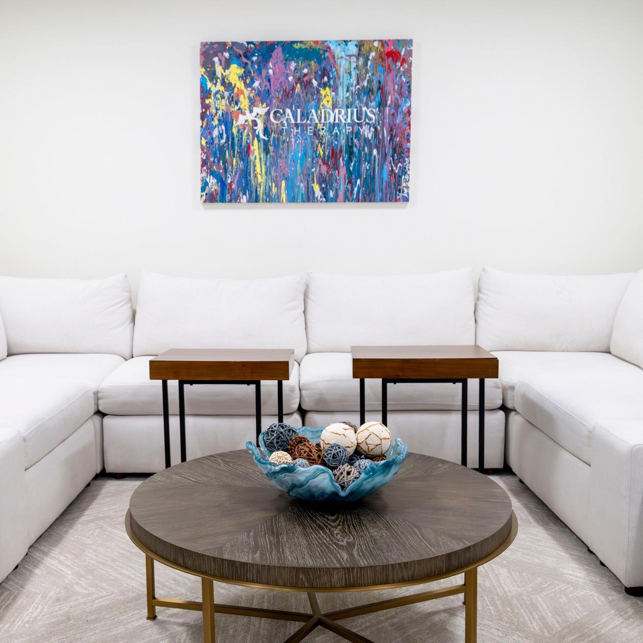 White couch seating area at Caladrius Therapy